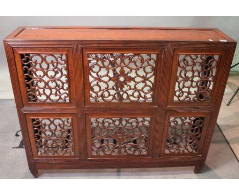 A late 19th century Chinese hardwood side cabinet fronted with six pierced scroll panels, on tapering square supports, altera