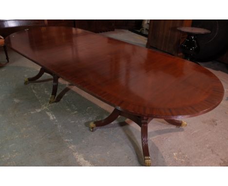 A George III style mahogany twin pillar dining table, on outswept supports, 306cm wide x 78cm high.  Condition Report Old mar