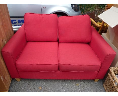 A modern John Lewis red upholstered, two seater sofa