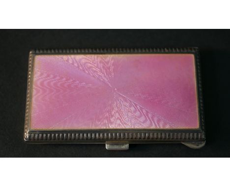 An Art Deco silver and pink guilloche enamel card case with engine turned decoration. Hallmarked: 925, London import mark, 19