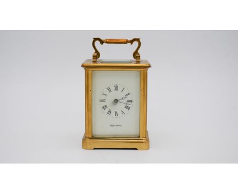 A gilt brass early 20th century carriage clock by Mappin &amp; Webb, white enamel dial with Roman numerals and with key. H.13