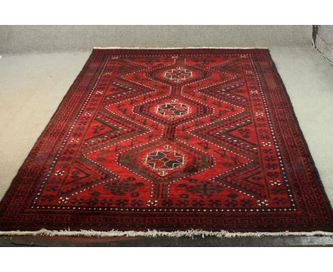 A red ground handmade Persian Lorestan carpet. L.256 W.175cm. 