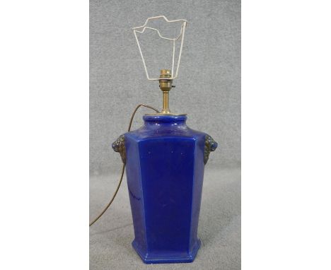 A cobalt blue glaze ceramic lamp with relief lionhead motifs. H.65 Diam.45cm 