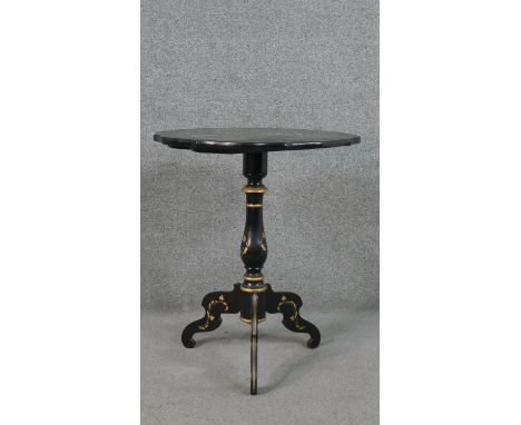 A black painted and parcel gilt tripod table, the top painted with flowers, on a turned stem, with scrolling tripod feet. H.7