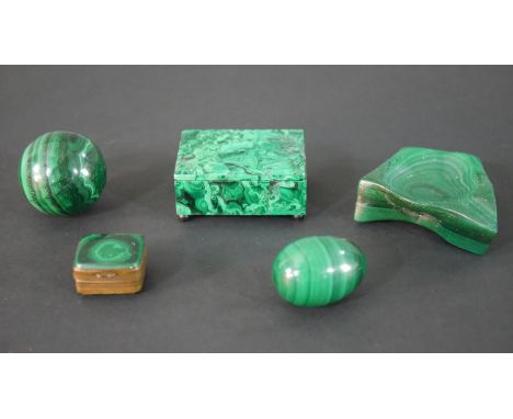 Two miniature malachite trinket boxes, one on four button feet along with a malachite ash tray, egg and sphere. H.3 W.7 D.7.5
