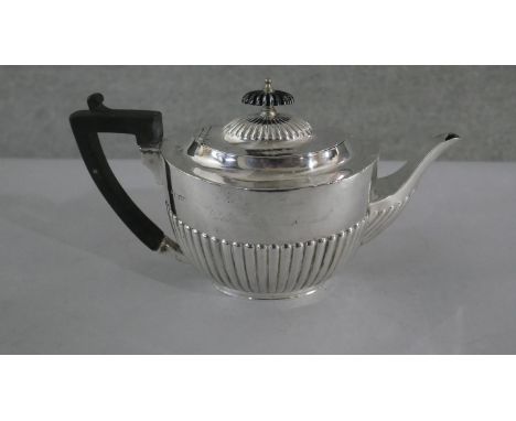 A Victorian silver gadrooned design tea pot with ebony handle and finial. Hallmarks rubbed. H.32 W.11cm Gross weight 615g 