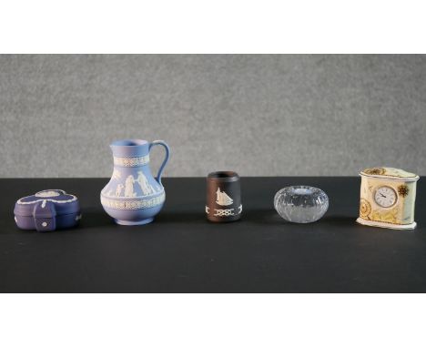 A collection of five Wedgwood pieces, including a Jasperware horse paperweight, a classical design jug, a Jasperware black na