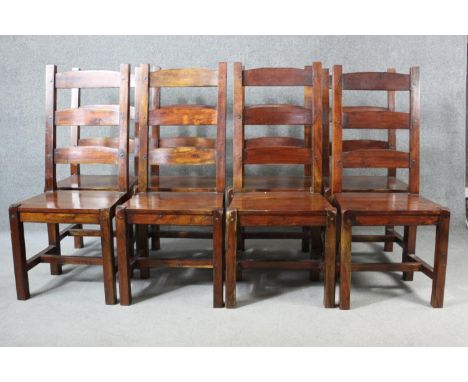 A set of eight mango wood ladder back dining chairs, the legs joined by H stretchers. 