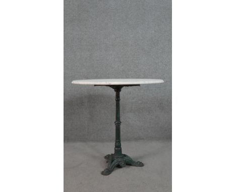 A cast iron bistro table, the circular marble top with a moulded edge, the painted base on tripod feet. H.73 Diam.75cm 