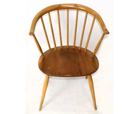 ERCOL; a light elm seated armchair on column supports.