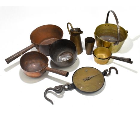 A quantity of brass and copper to include jam pans, jugs and a hanging scale.