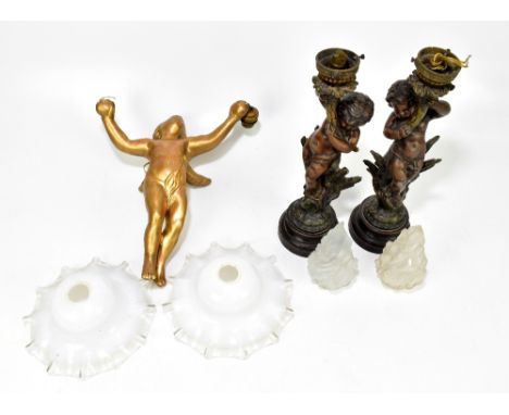 A gilt plaster ceiling light fitting in the form of a cherub (af), with a pair of bronzed spelter table lamps, modelled as ch