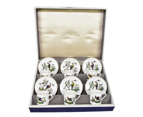 ROYAL WORCESTER; a cased six setting coffee set comprising six coffee cans and six saucers, each with tinted printed decorati