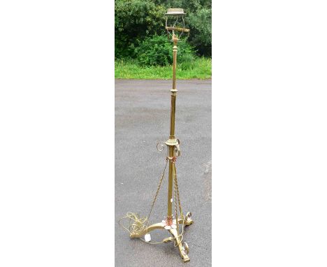 An early 20th century Arts and Crafts brass plated and copper rise and fall standard lamp, converted from an oil lamp, height