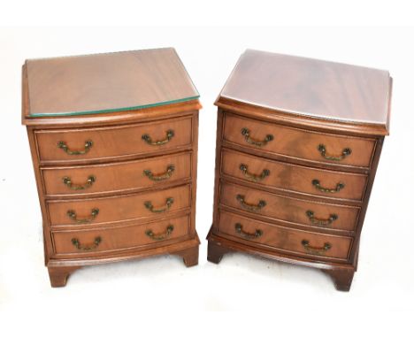 A pair of reproduction bow-fronted four drawer chests of drawers on bracket feet, height 60cm, width 45cm, depth 33cm.&nbsp;A