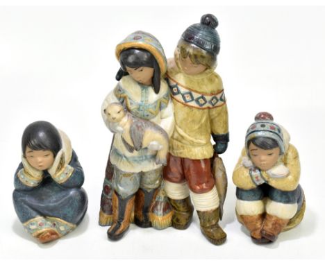 LLADRO; three salt glazed ceramic figures of Inuits, including a boy and girl holding a seal, height 30cm, etc.Additional Inf