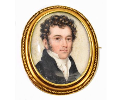 An early 19th century oval portrait miniature set in yellow metal brooch/pendant frame, the portrait depicting a young man we