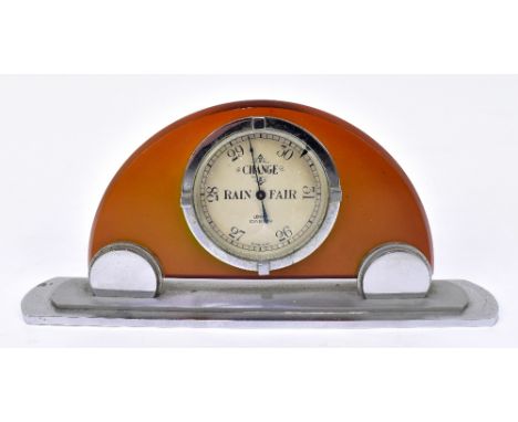 LENNIE OF EDINBURGH; an Art Deco chrome mounted table aneroid barometer with amber coloured body, width 21cm.Additional Infor