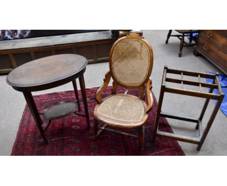 An early 20th century beech framed cane seated rocking chair, Gothic hall chair, oak stick stand and oak table (4).