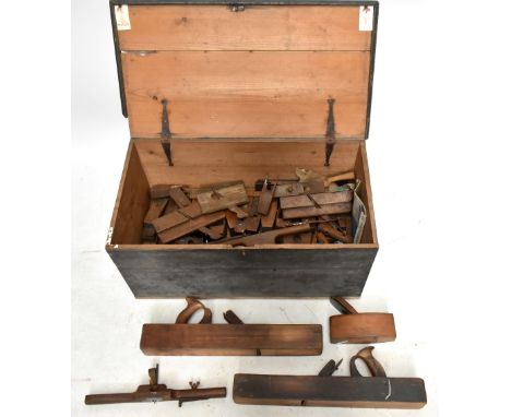 An early 20th century pine tool chest enclosing an assortment of planes and tools.&nbsp;