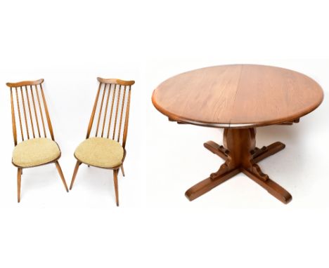 ERCOL; a medium elm circular extending dining table and six stick back chairs (7).&nbsp;Additional InformationLight scratches