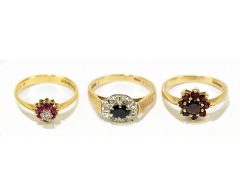 An 18ct yellow gold diamond and ruby set dress ring, approx. size N, with two 9ct gold dress rings, including an example with