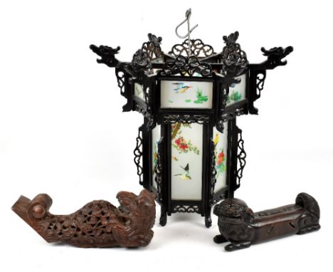 A modern Chinese carved hardwood hanging lantern of hexagonal form with frosted glass panels printed with birds, height 40cm.