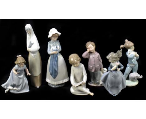 NAO; a collection of seven ceramic figures, to include a girl with a puppy, a boy with a teddy bear, and a maiden with a pupp