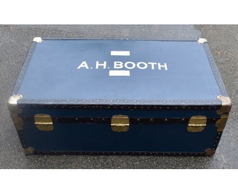 A mid century studded travelling trunk, with printed name 'A.M. Booth'.&nbsp;