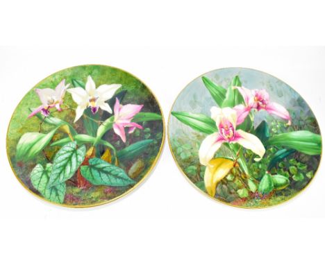 ROYAL WORCESTER; a pair of hand painted ceramic wall plaques, each decorated with floral scenes, incised signature ‘C Stephan