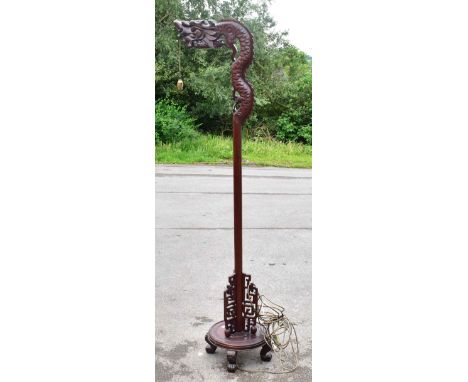 An early 20th century Chinese carved rosewood standard lamp in the form of a dragon, height 185cm.&nbsp;