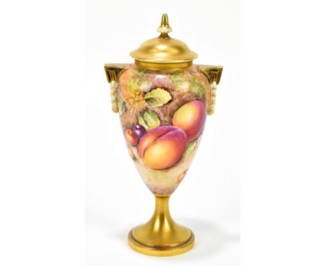 E HIGGINS FOR ROYAL WORCESTER; a hand painted pedestal lidded vase with moulded handles, decorated with fruit, with black mar