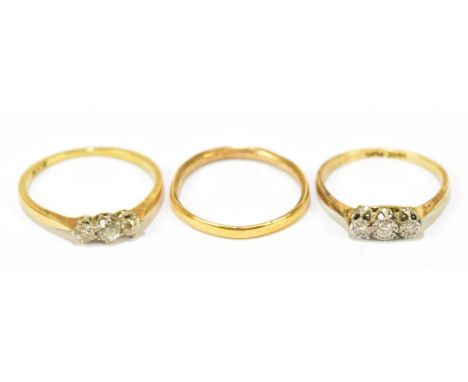 An 18ct yellow gold three stone diamond dress ring with platinum shoulders, approx. size M 1/2, with a similar 10ct example, 