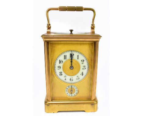 A late 19th century French gilt brass repeating carriage clock, the gilt dial with engine turned detailing, with Arabic numer