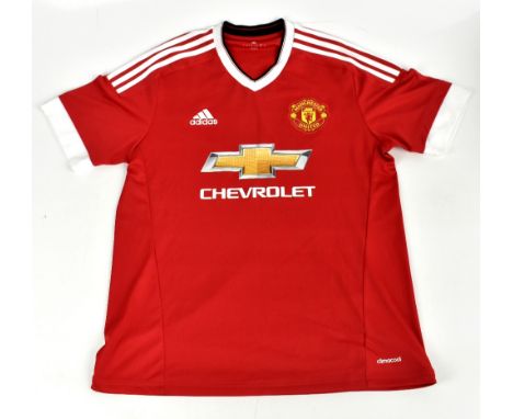 ERIC CANTONA; a Manchester United 2015 home shirt, signed to the reverse, size large.Additional InformationCreasing and light