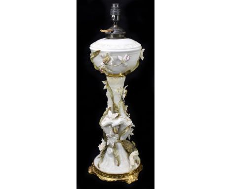 MOORE BROS; a large ceramic oil lamp with applied floral decoration on an ivory ground with gilt highlights, printed marks to