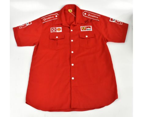 MICHAEL SCHUMACHER; a Ferrari racing shirt, signed to the front, size XXL.Additional InformationCreasing and light general we