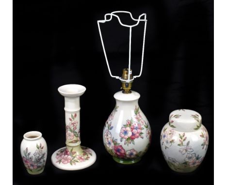 MOORCROFT; four Spring Blossom pattern items comprising an ovoid lamp, height 25cm, a candlestick, a small vase, and a ginger