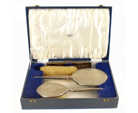 H CLIFFORD DAVIS LTD; an Elizabeth II silver backed four piece dressing table set, comprising mirror, hairbrush, comb, and cl