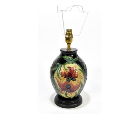 A modern Moorcroft lamp decorated with flowers against a green ground, height 30cm.&nbsp;Additional InformationGood condition