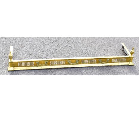 An Edwardian Adam style pierced brass fender, length 125cm, with a white painted brass and iron standard lamp (2).