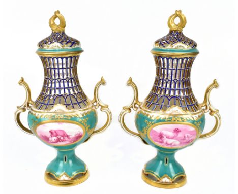 MINTONS; a pair of late 19th century green ground gilt heightened reticulated vases and covers, the openwork lids set with en