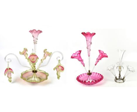 A Victorian ruby glass three branch epergne, height 52cm, with a larger epergne and a smaller clear glass epergne with matche