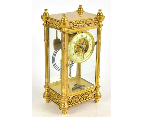 A late 19th century French gilt brass four glass mantel clock, with Roman numeral chapter ring and movement striking on a gon