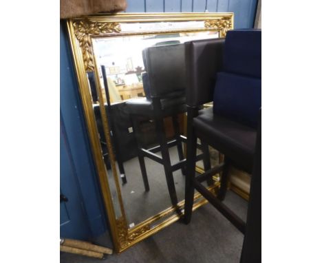 A large gold gilt mirror with inset bevelled glass panels. 