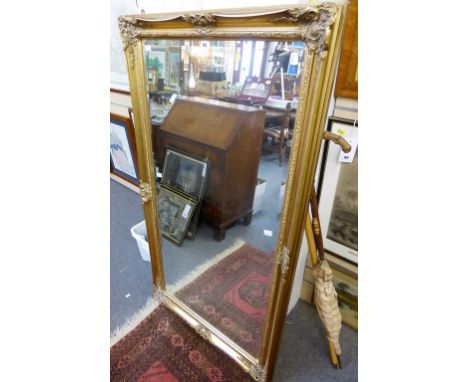 A large bevelled glass gold gilt mirror. 
