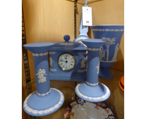 A small collection of Wedgwood Blue Jasparware to include a mantle clock, barometer, vase and two candle sticks. 