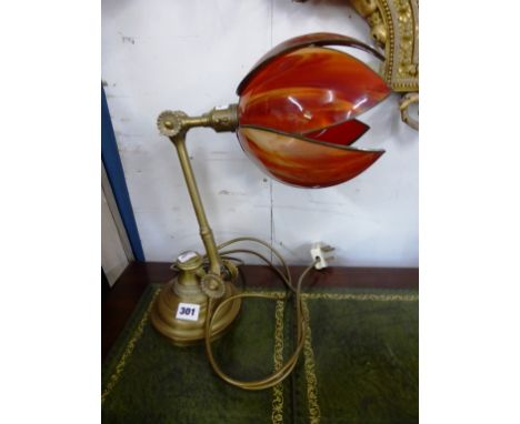 Hinged brass desk lamp with orange glass shade. 