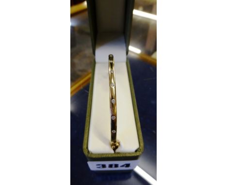 A 9ct gold and diamond bangle   