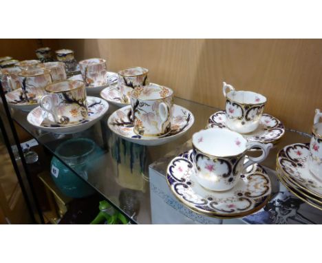 A set of seven early 19th century Derby porcelain coffee cans   painted with Imari style decoration with fruiting vines and b